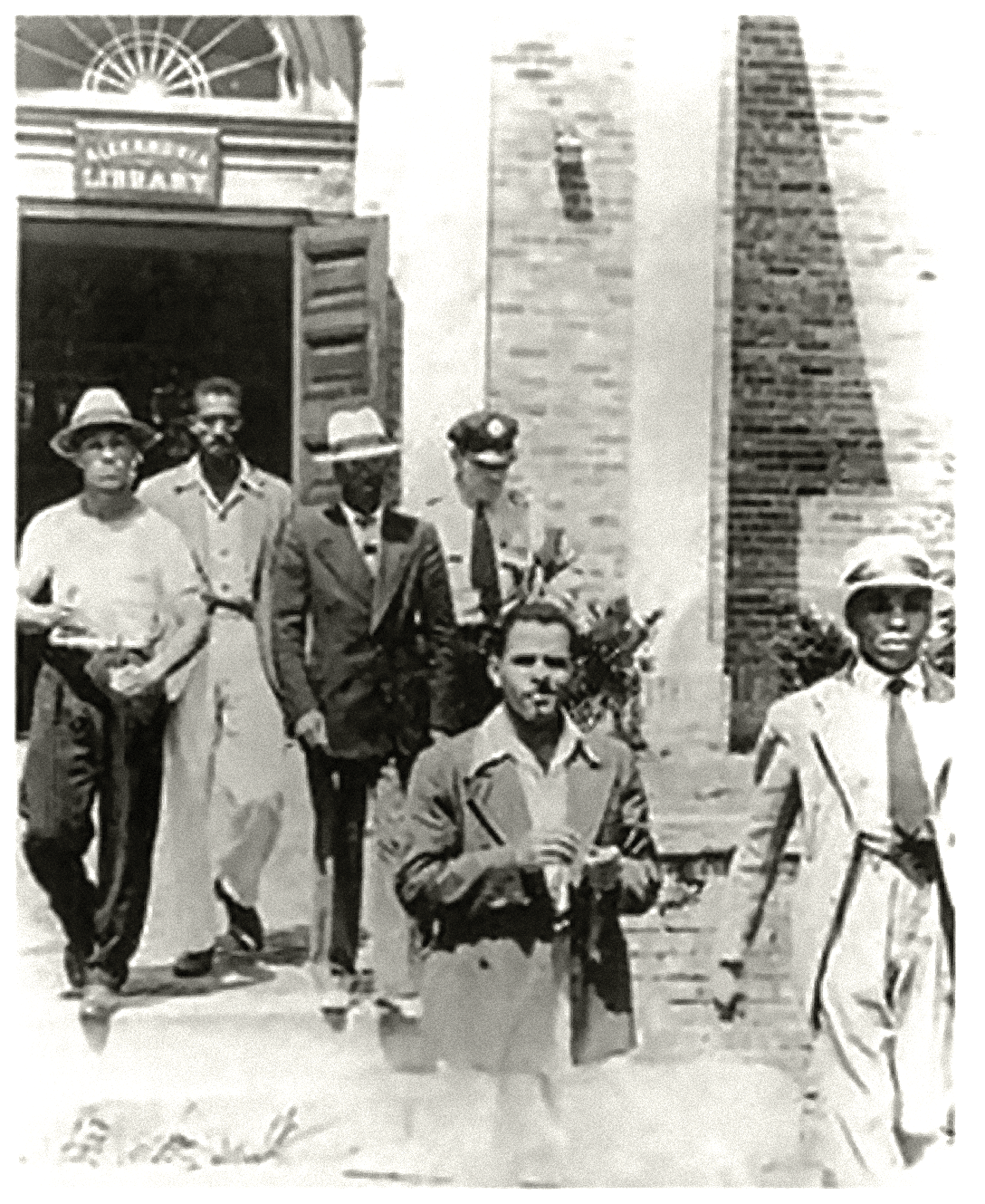Black men are arrested and led away by police after conducting a sit-in at the all-white public library in Alexandria, August 21, 1939. Alexandria Black History Museum.