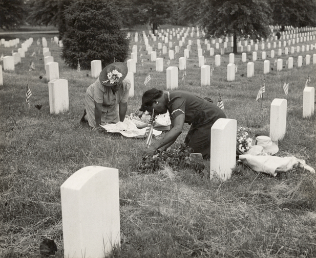Decorating a soldier’s grave in one of the Black sections of Arlington Cemetery, Arlington, Va., May 1943. Source: Esther Bubley, New York Public Library.