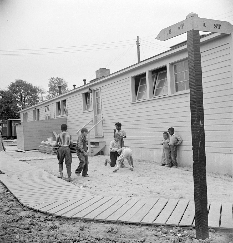 Arlington, Virginia. FSA (Farm Security Administration) trailer camp project for Negroes. Children playing marbles outside the community building. Source: Library of Congress.