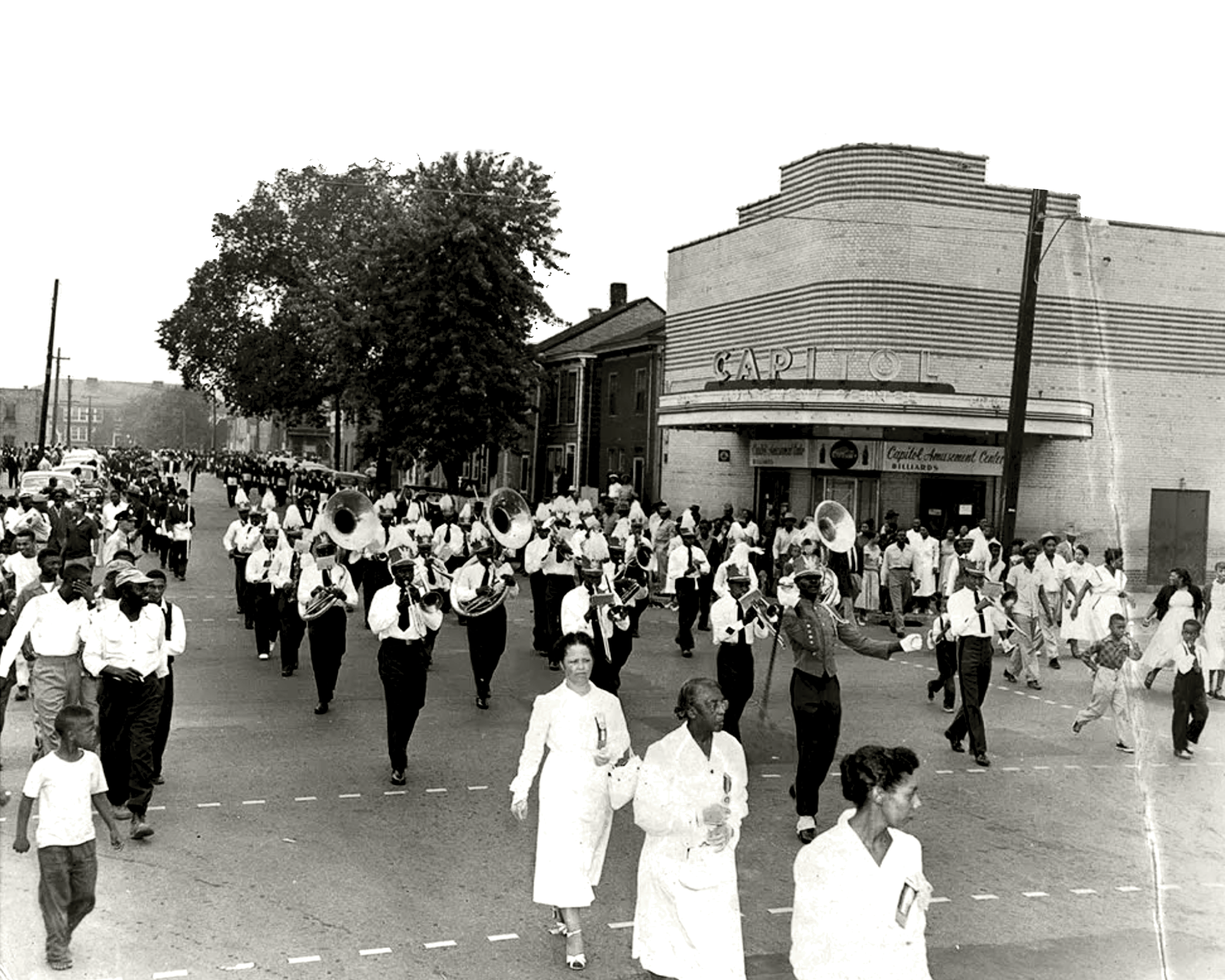 Parade along Queen Street, in front of the Capitol Theater. The Capitol was the first theater for Black patrons in Alexandria, and continued to serve the Black community throughout the era of segregation. Alexandria, 1950. Source: The American Legion William Thomas Post 129, photographer unknown.