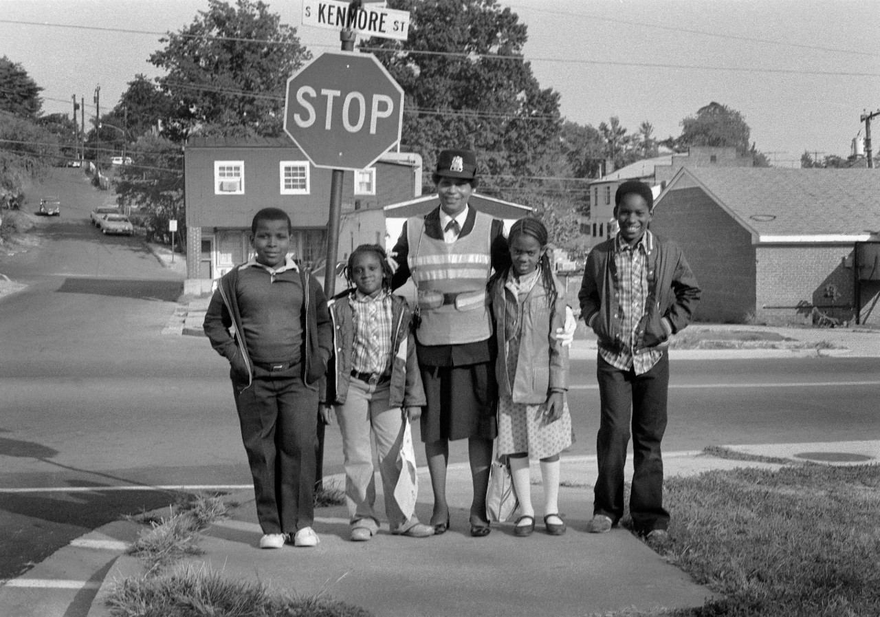 Crossing guard and students on South Kenmore Street, in the Green Valley area of Arlington, 1980. Photo by Lloyd Wolf.